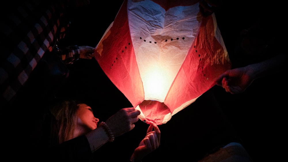 a man holding a red and white flag