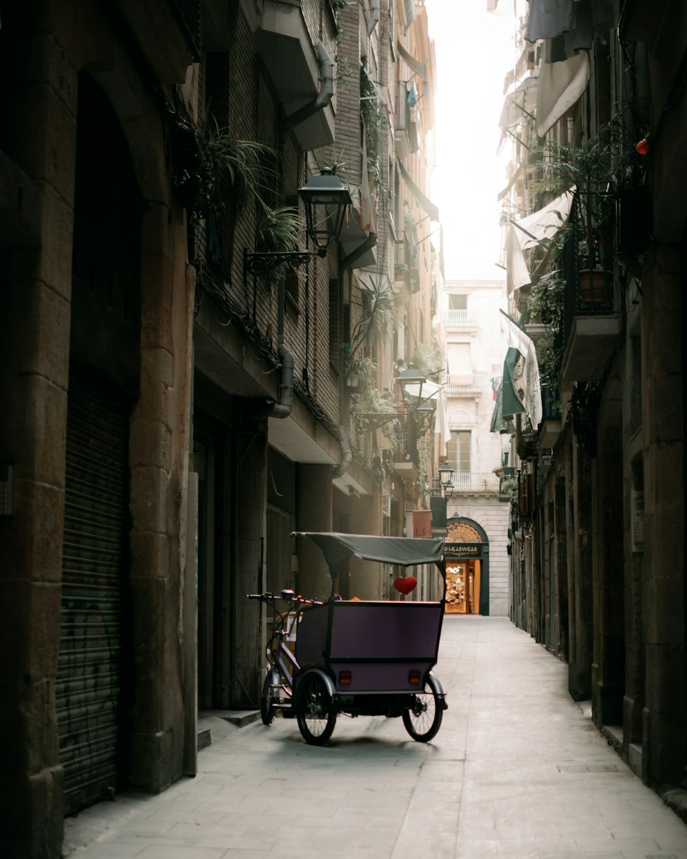 a bicycle parked in a narrow alley