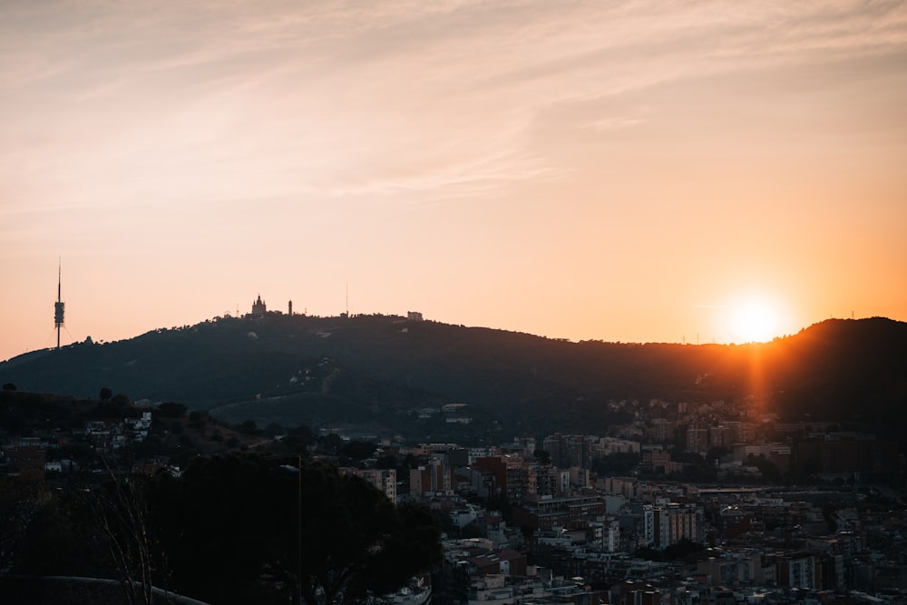 a city with a sunset in the background