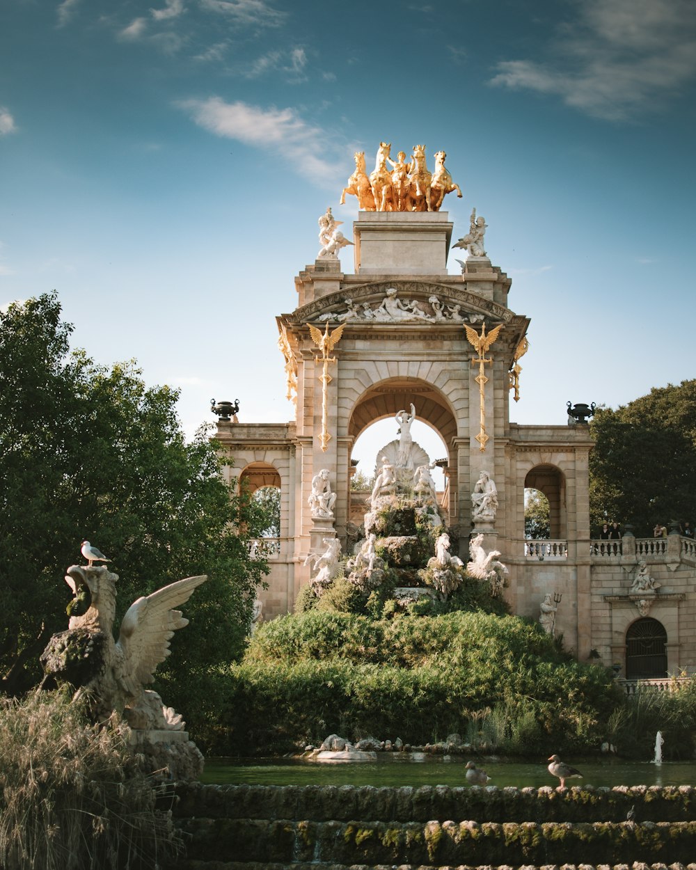 a large stone building with a statue in front of it