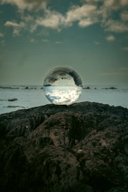 A serene setting with a clairvoyant gently holding a glowing crystal ball.