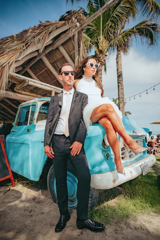 a man and woman posing for a picture next to a pool