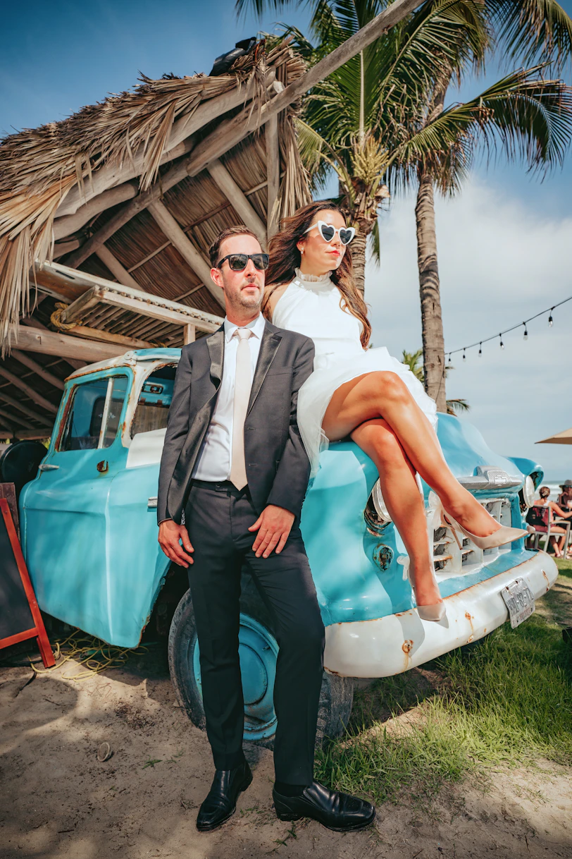 a man and woman posing for a picture next to a pool