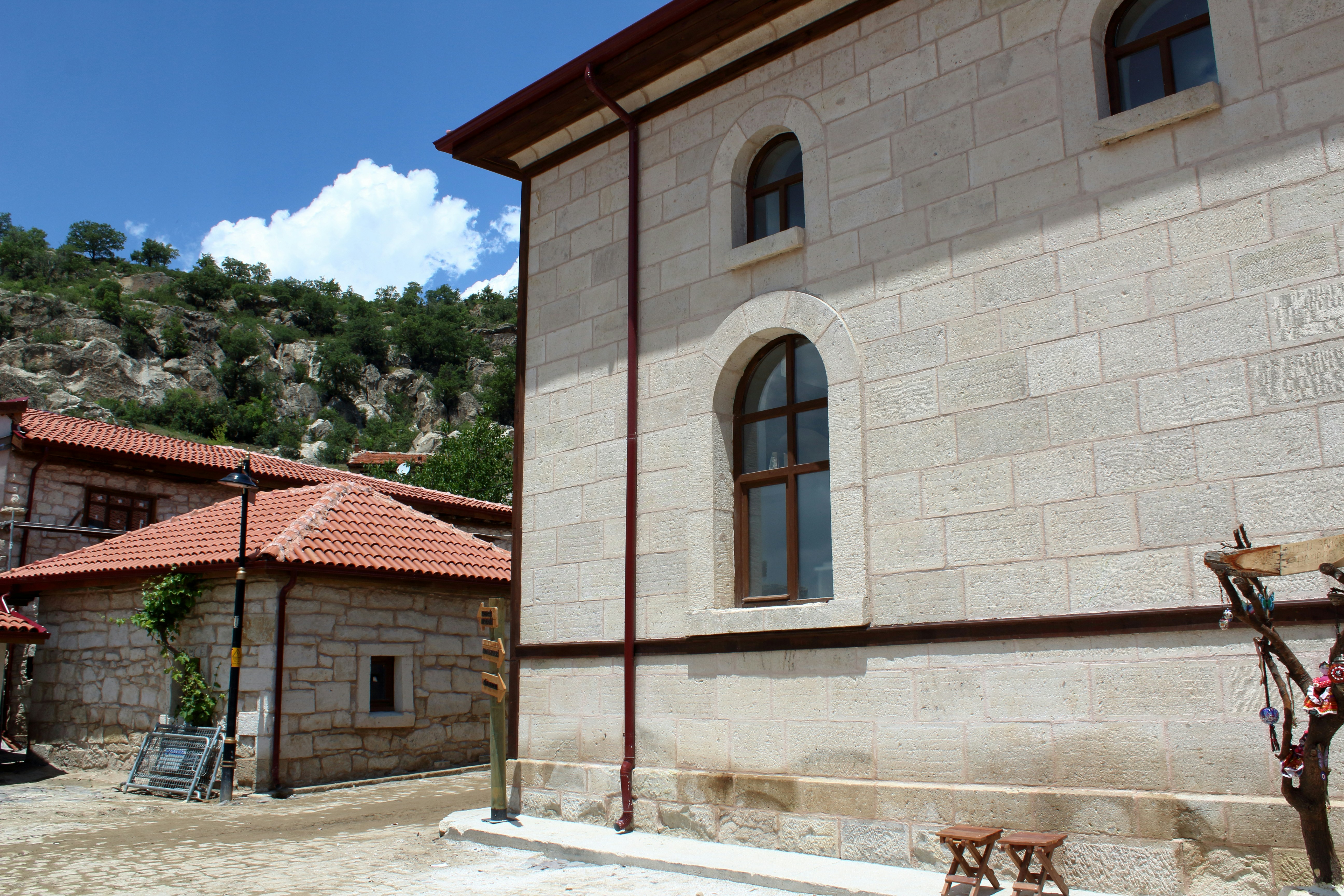 a stone building with a red roof