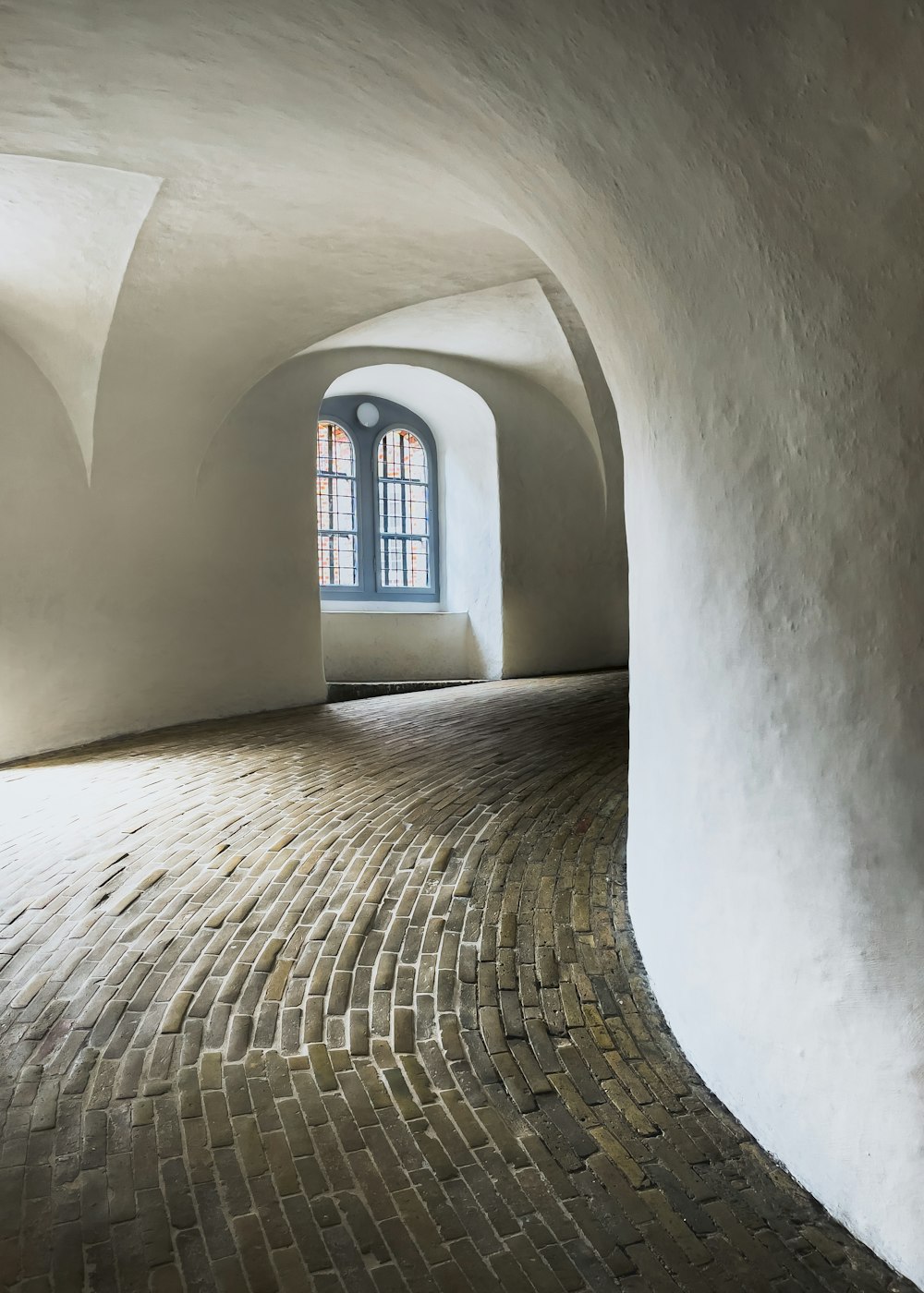 a stone hallway with a window