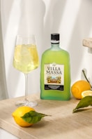 a bottle of alcohol next to a glass of wine