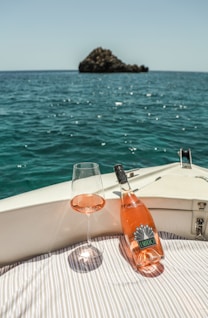 a glass of wine on a boat