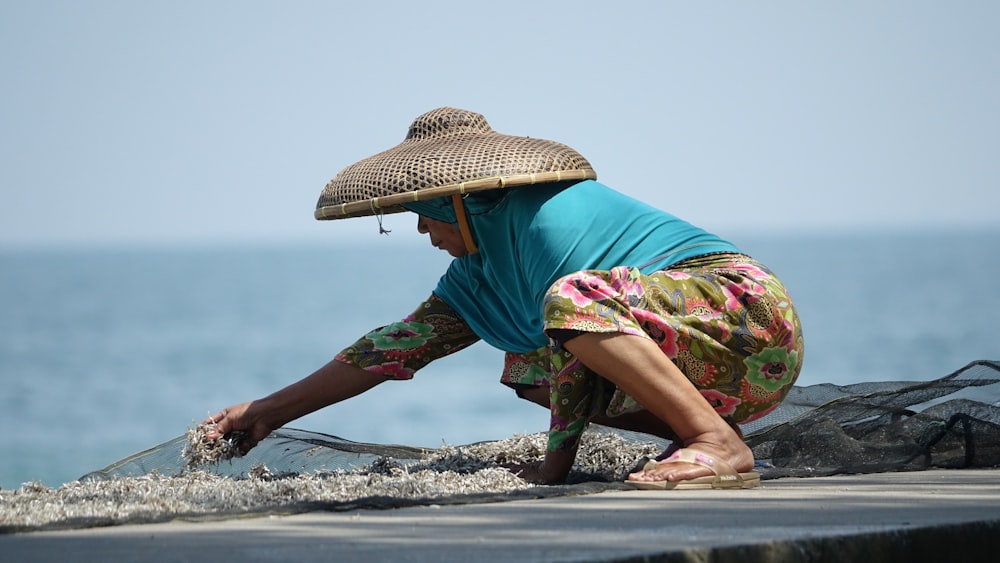 a man wearing a hat and holding a fishing pole