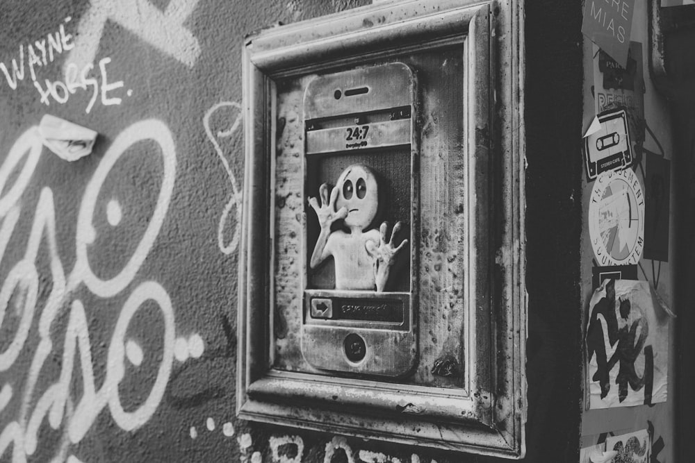 a black and white photo of a door with graffiti on it