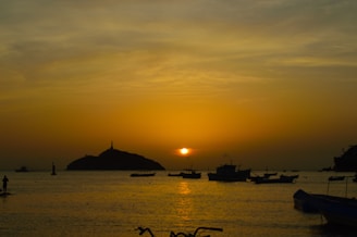 Sunset over the serene waters surrounding Isla del Sol with traditional boats.