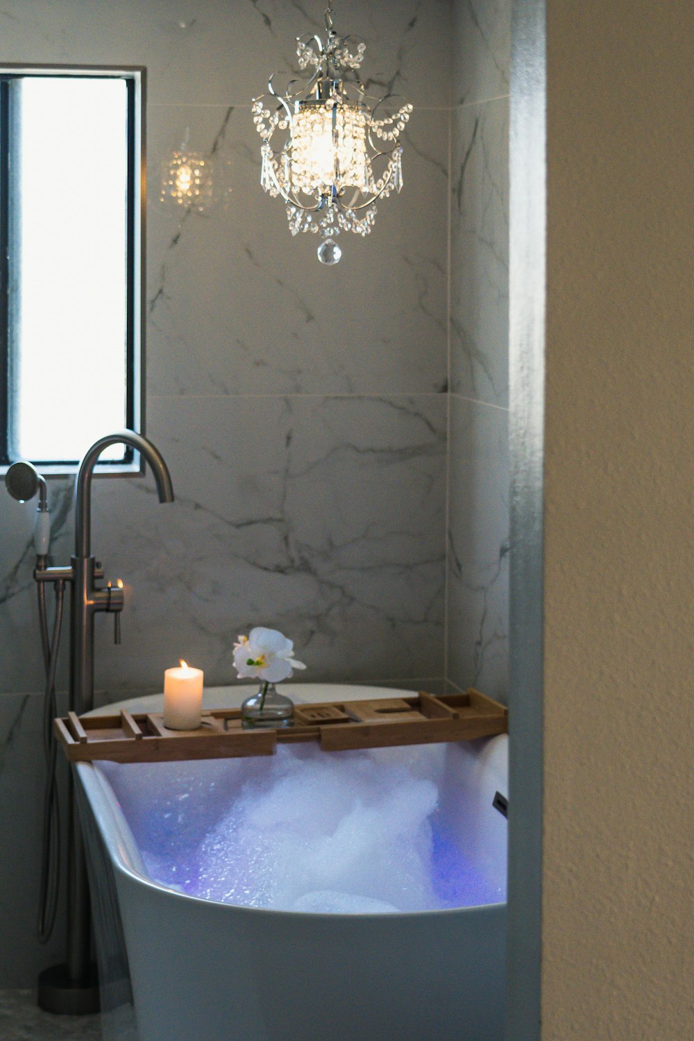 a sink with a chandelier above it