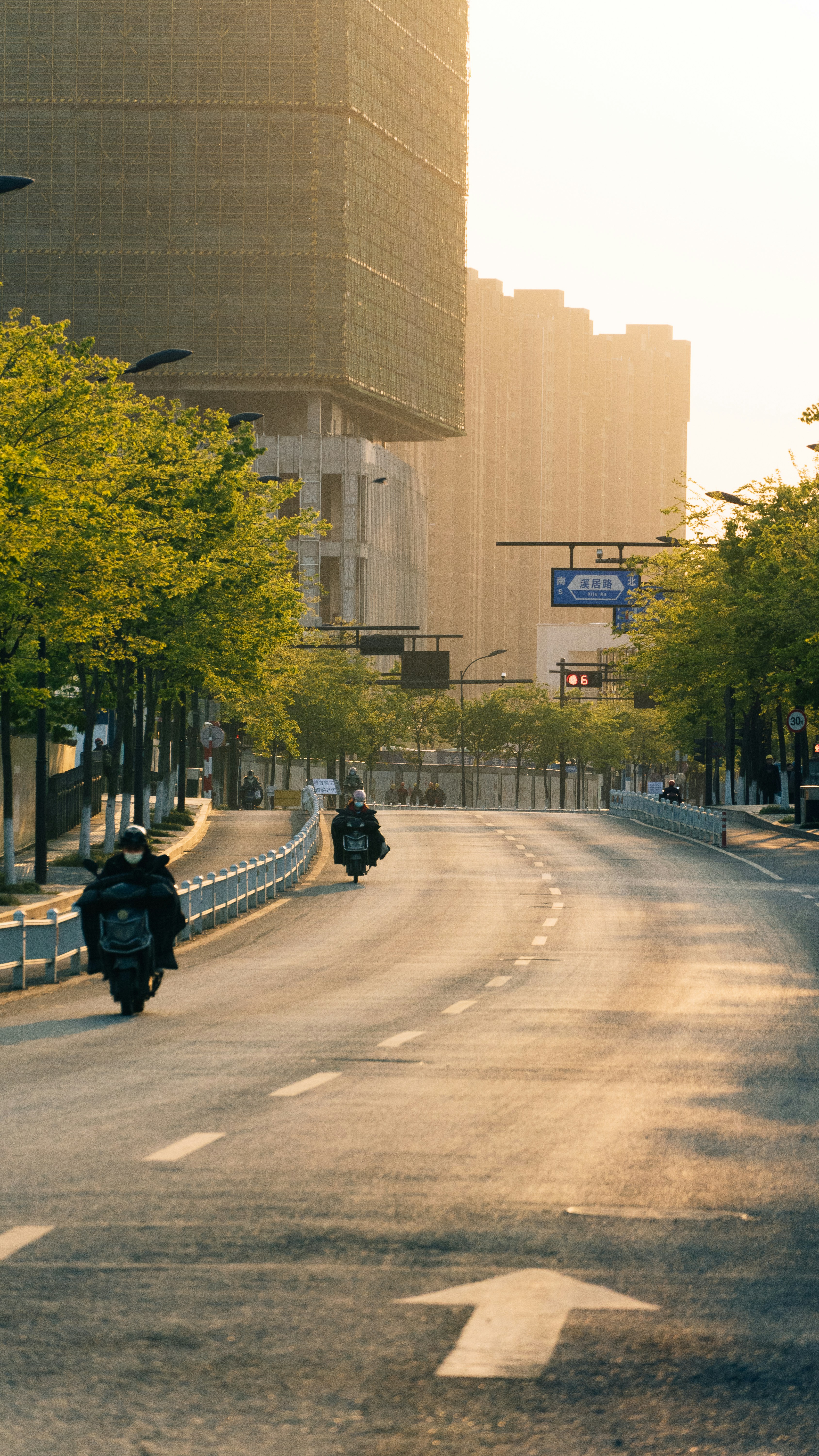 a person riding a motorcycle down a street