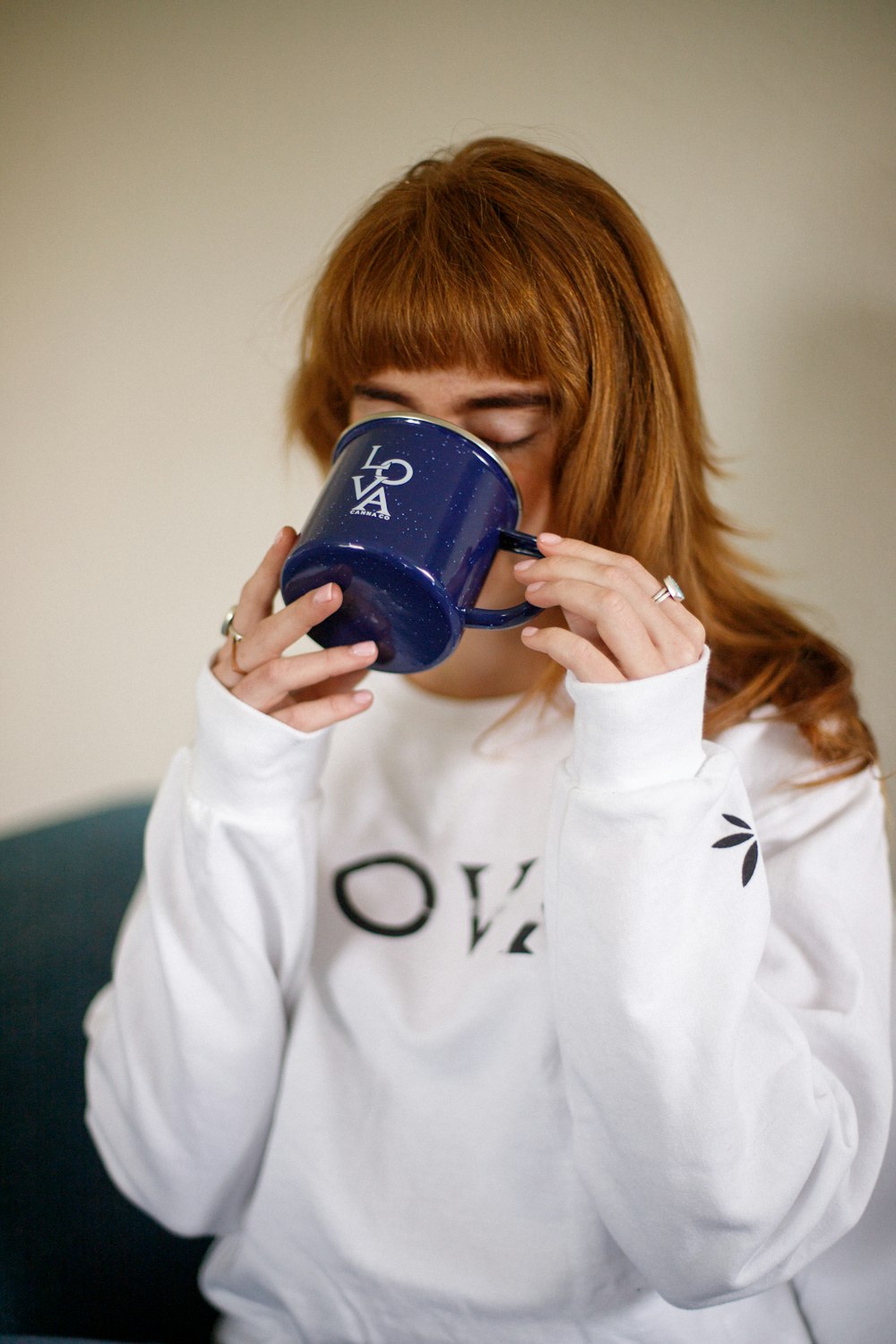 a person holding a blue cup