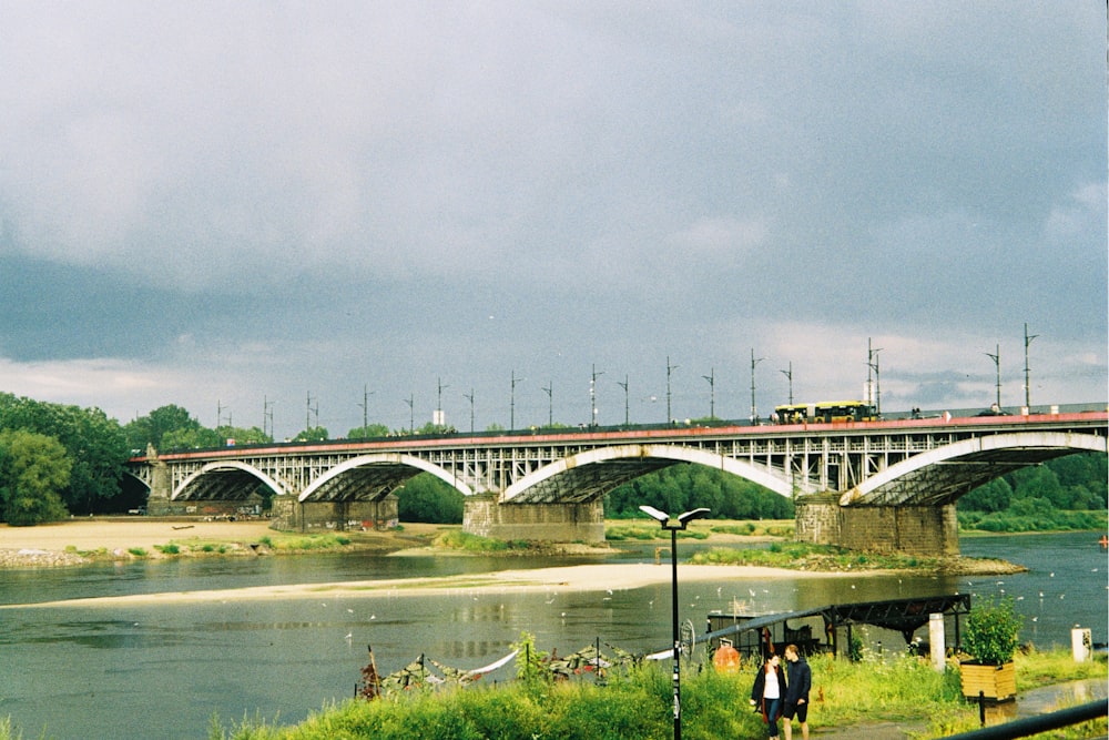 a train crossing a bridge over a body of water