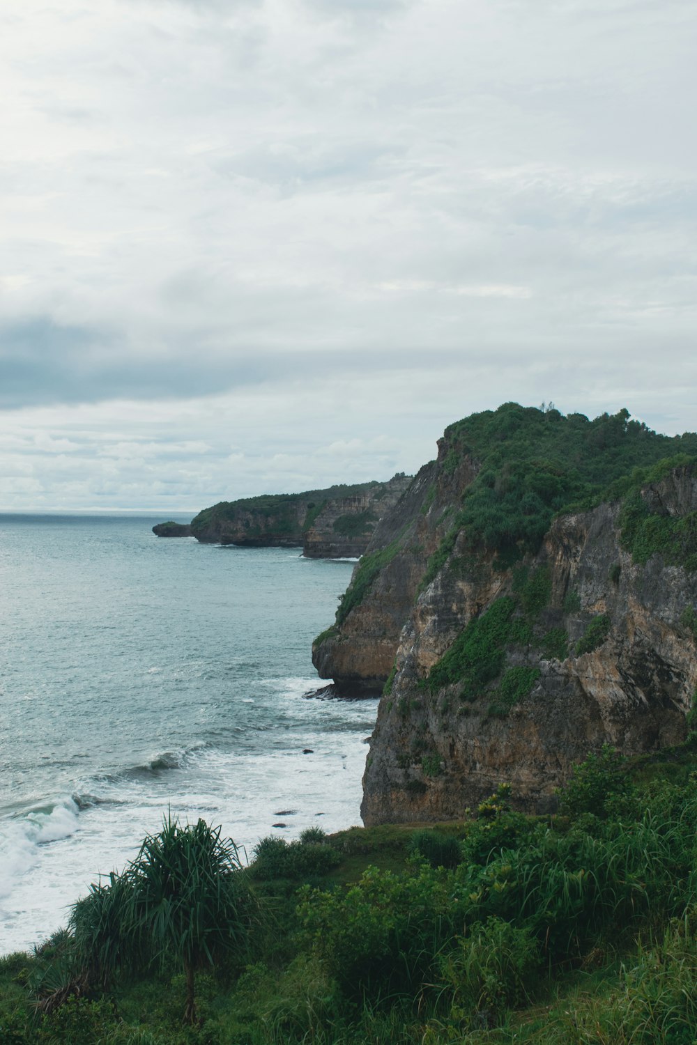 a cliff with a body of water below