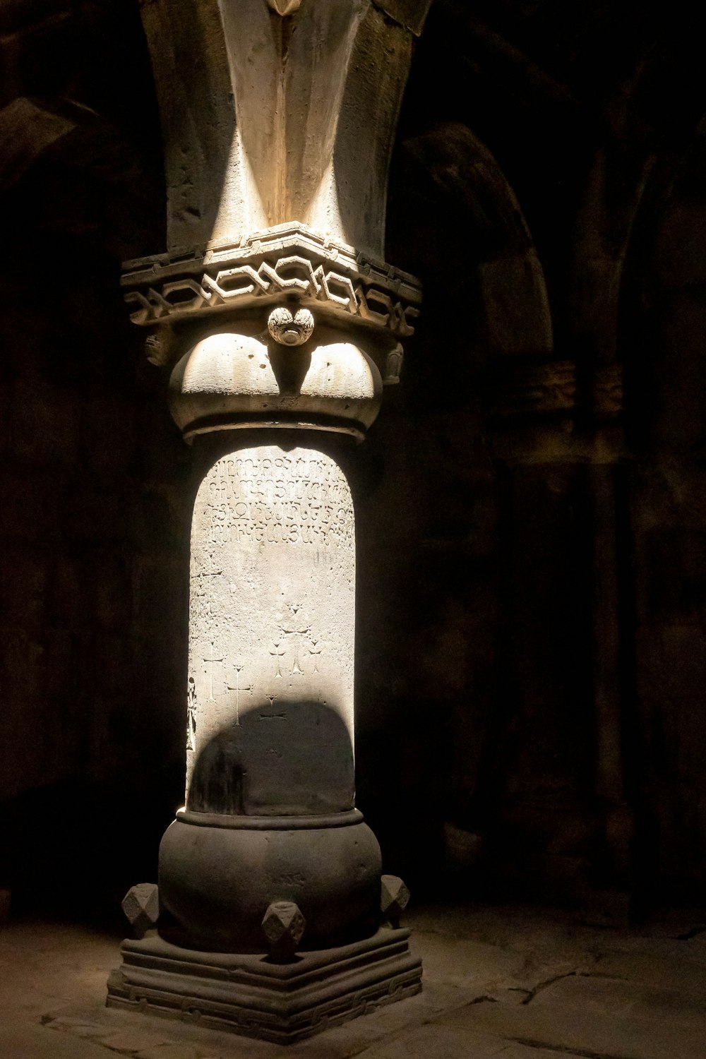 a large vase sits in a dark room