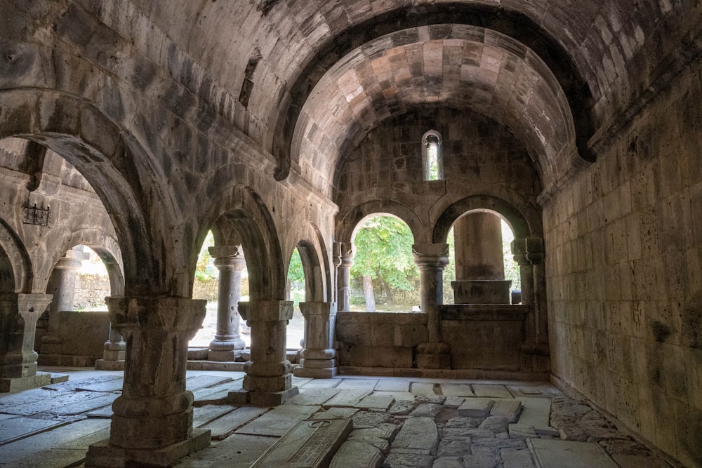 a stone walkway with arches and columns