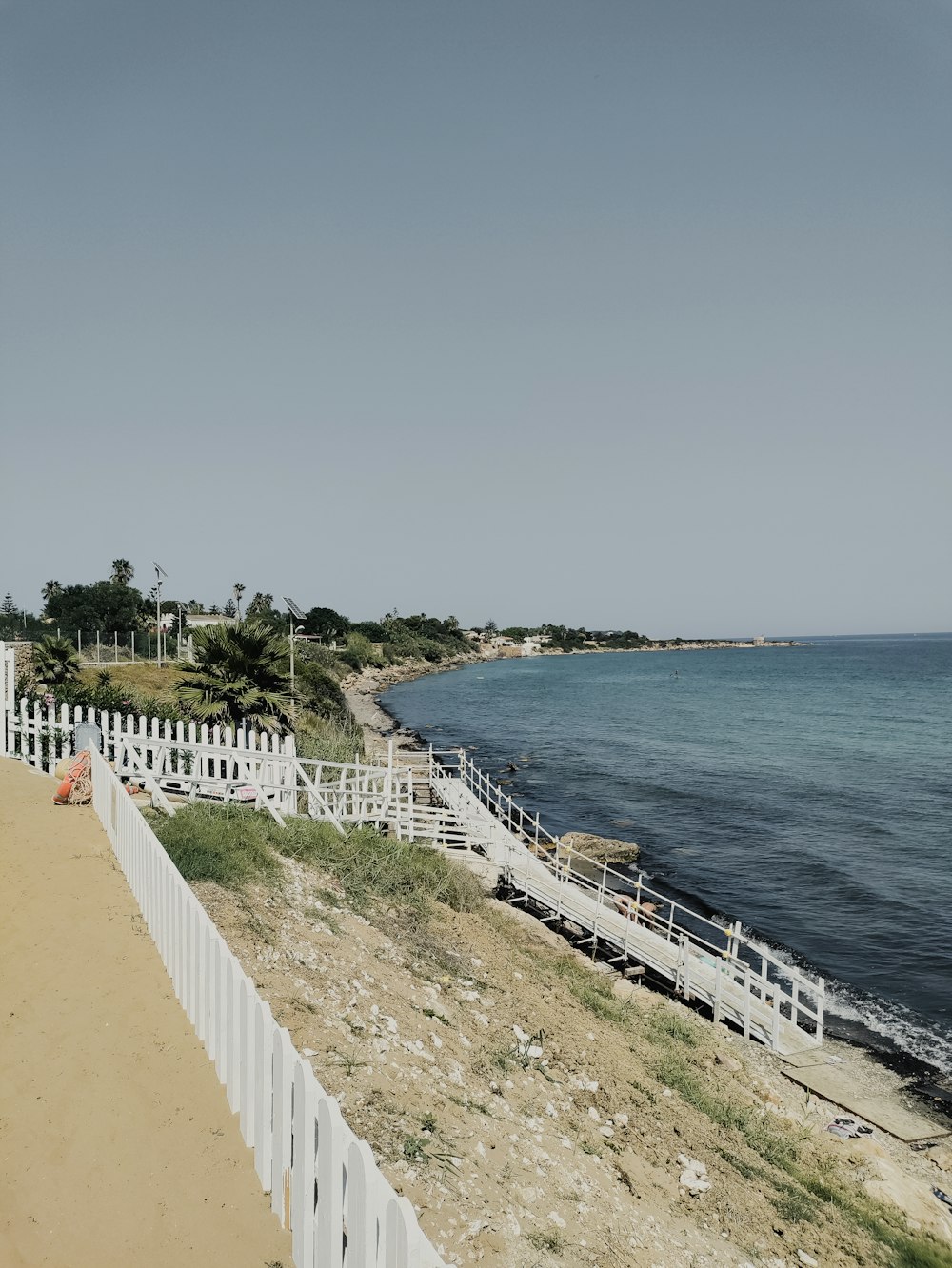 a white fence along a beach