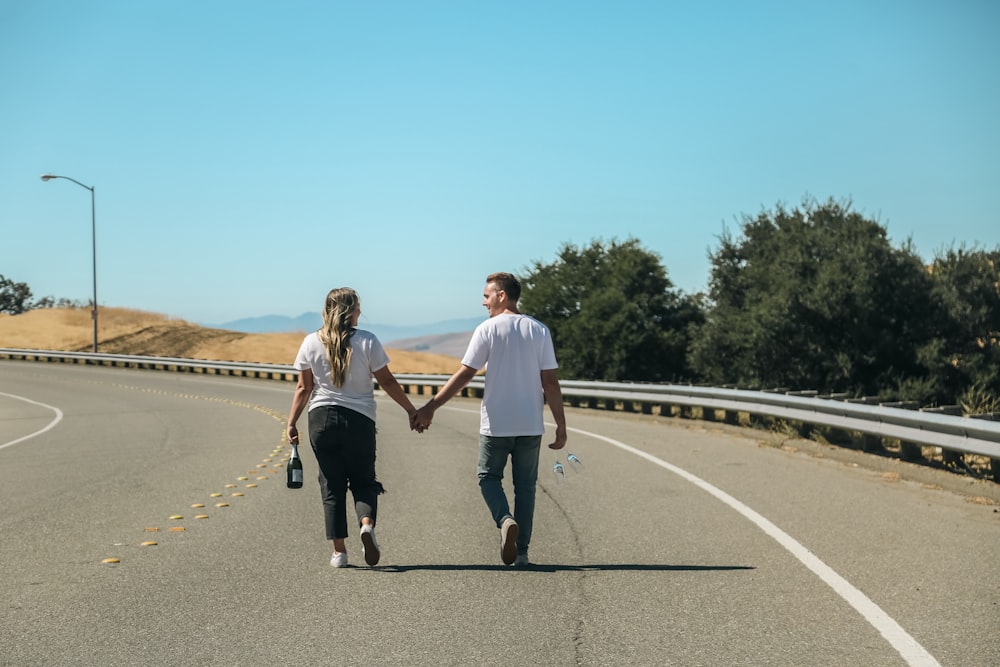 a man and a woman walking on a road