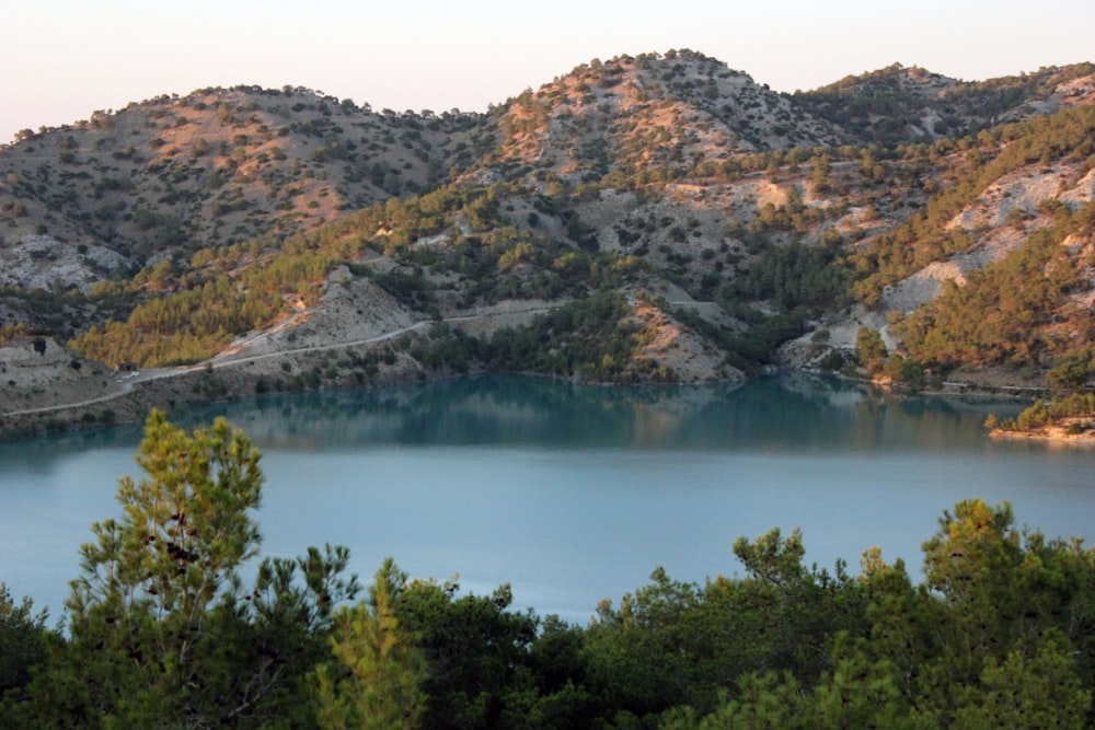 a lake surrounded by trees and mountains