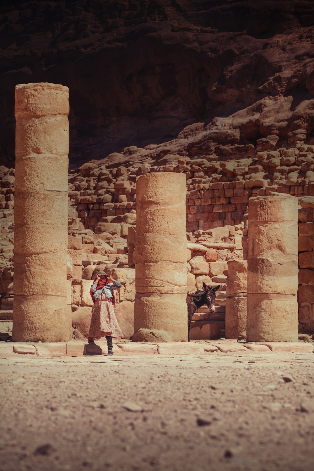 a person standing next to a stone building