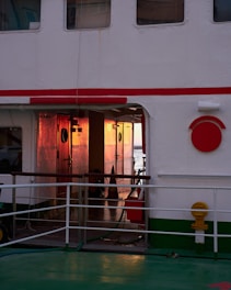 a white building with red and white doors