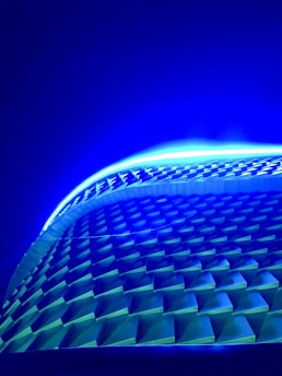 A vibrant digital altar landscape featuring sacred geometry patterns glowing with electric blue and violet hues.