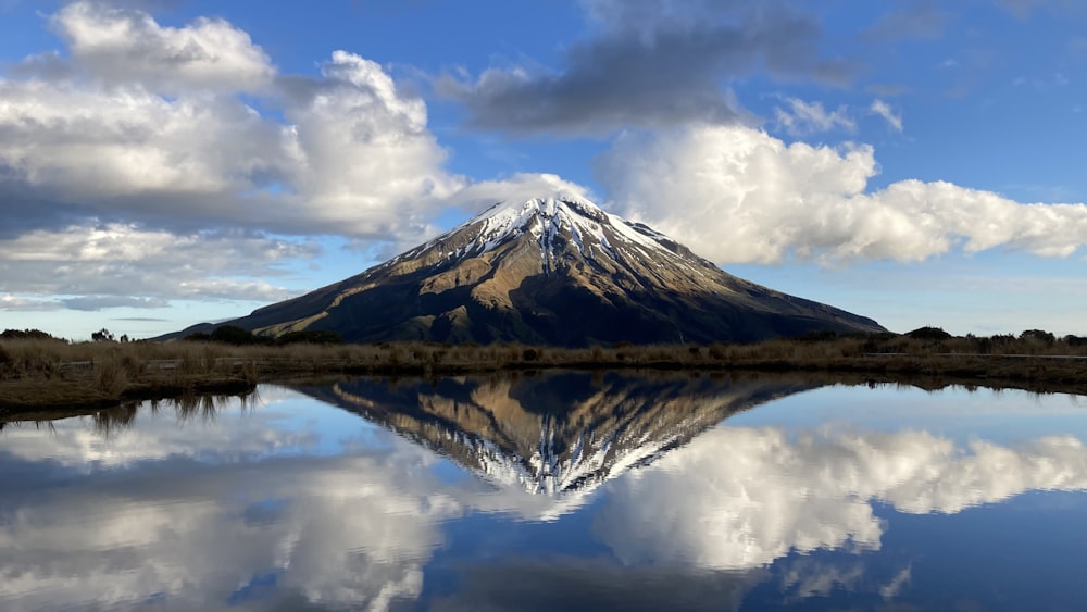 a mountain reflected in water
