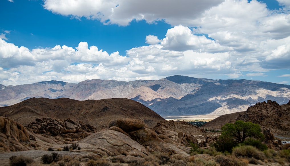 a landscape with mountains and clouds