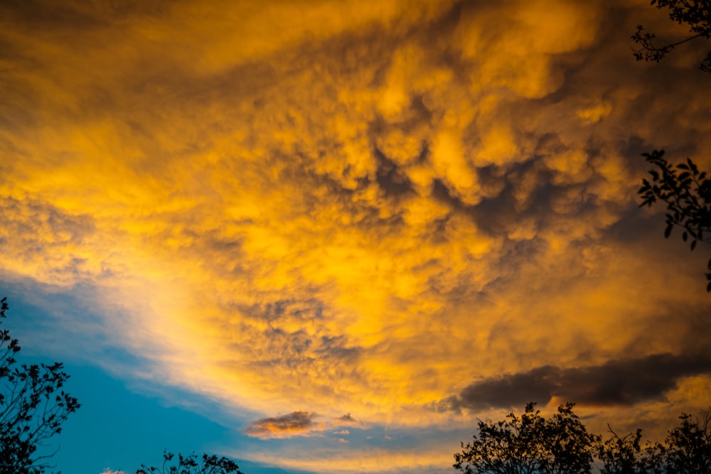 a yellow sky with clouds