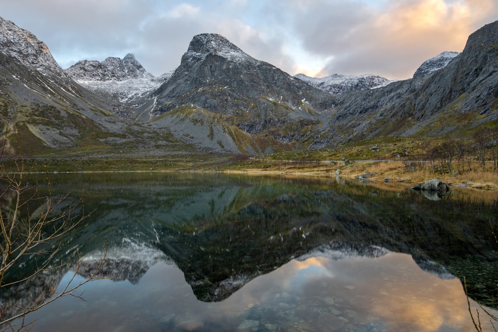 a lake in front of mountains