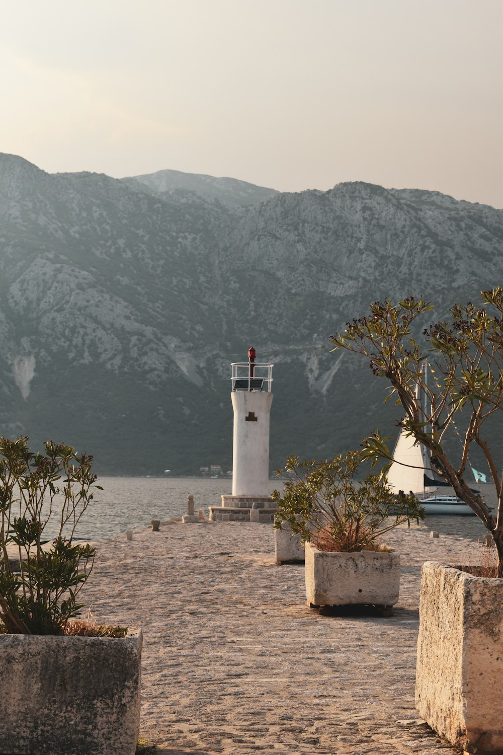 a white lighthouse on a rocky beach
