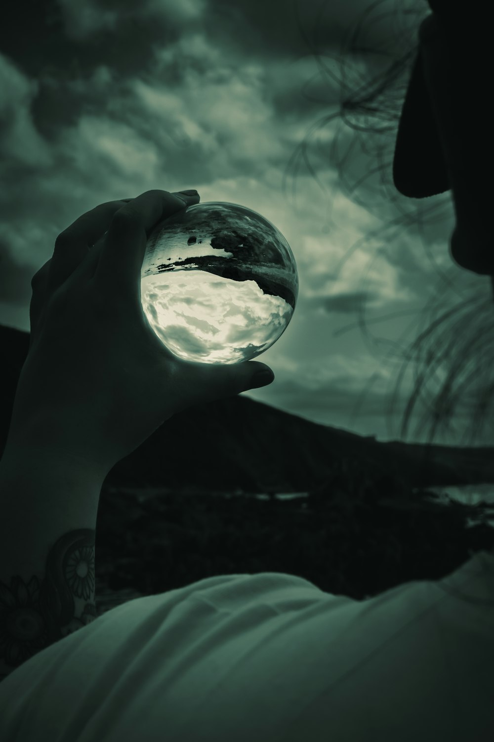 a hand holding a glowing light bulb