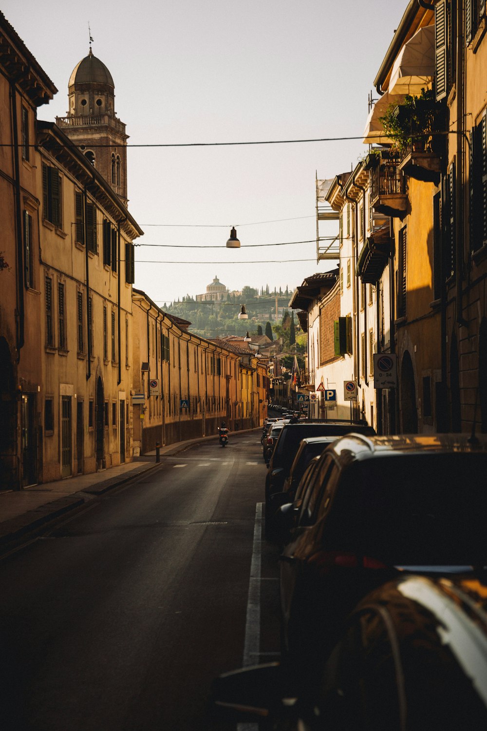 a street with cars on it and buildings on the side