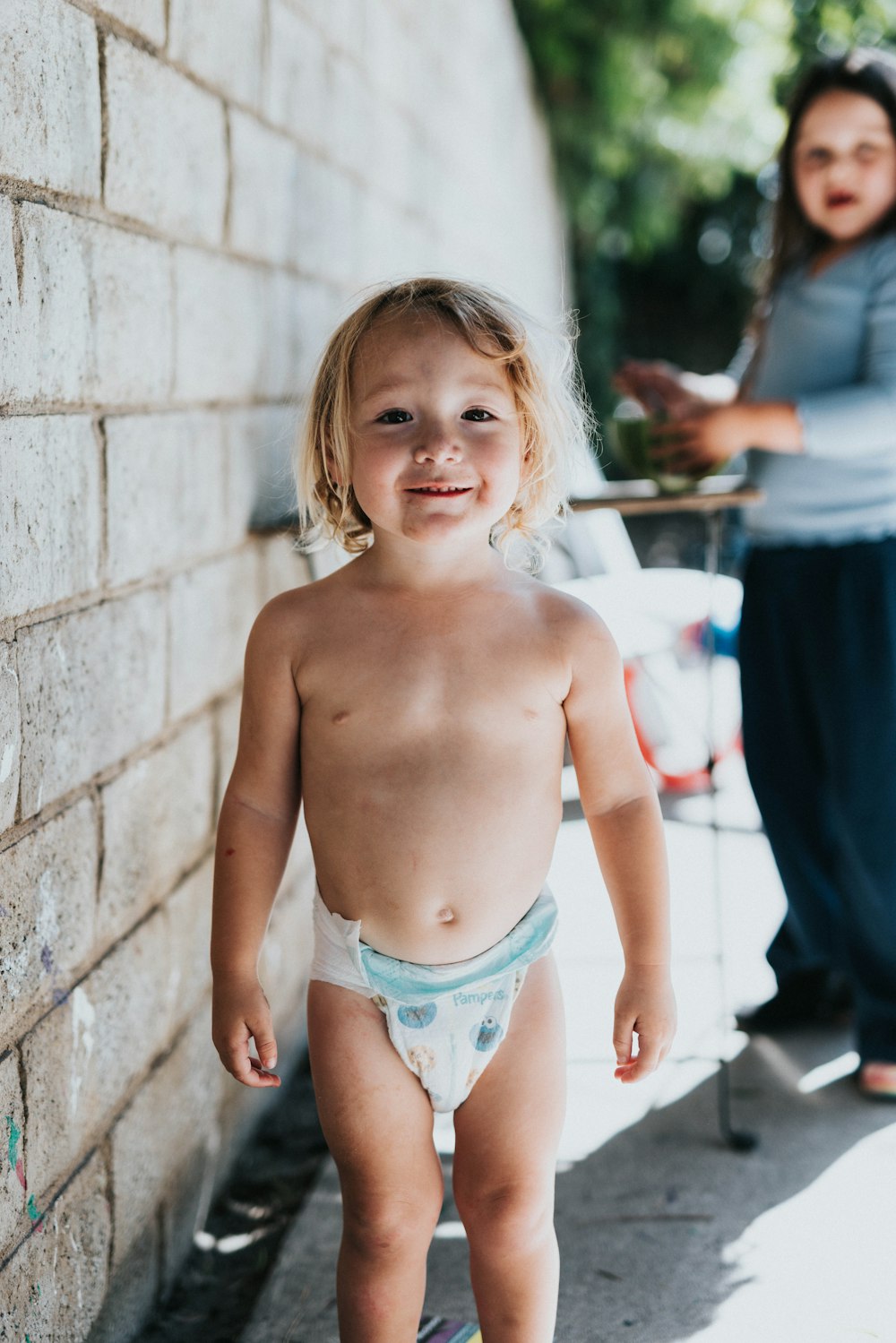 a child standing by a wall