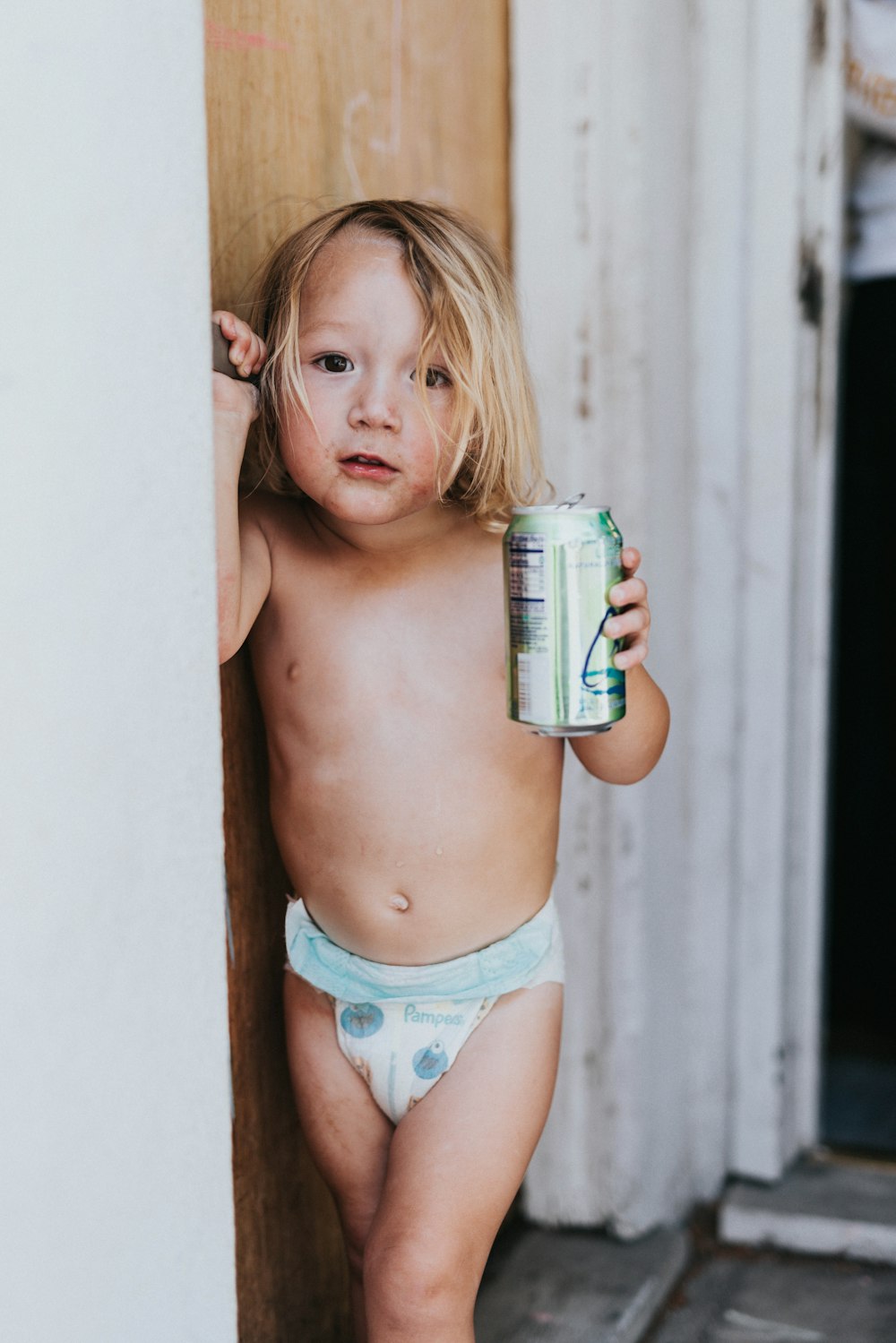 a child holding a can