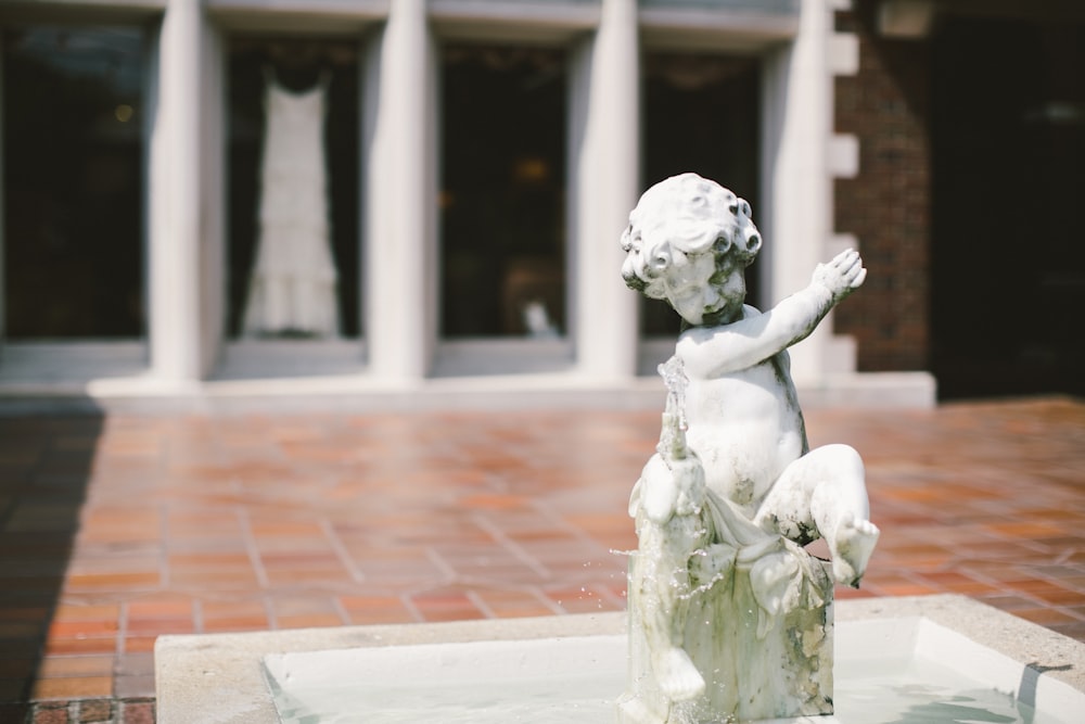 a statue of a person holding a baby