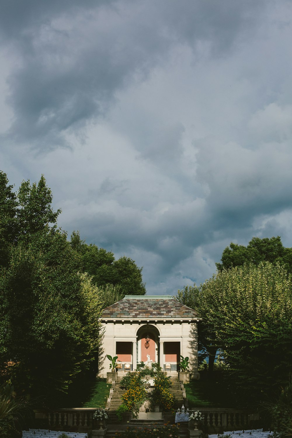 a building with a large archway surrounded by trees