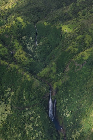 A breathtaking view of the lush Hawaiian mountains and waterfalls.