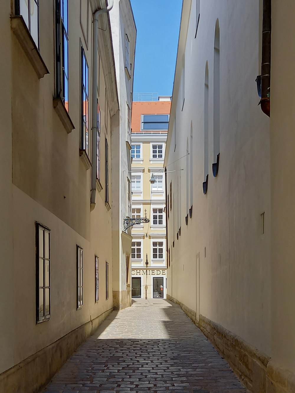 a cobblestone street between buildings