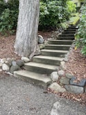 Stone steps ascending through a garden, showcasing expert craftsmanship and design.