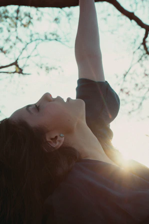 a person lying on the back in a tree