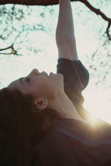 a person lying on the back in a tree