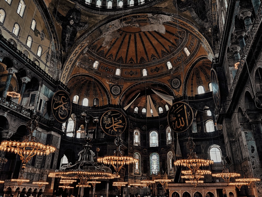 a large ornate building with many clocks with Hagia Sophia in the background