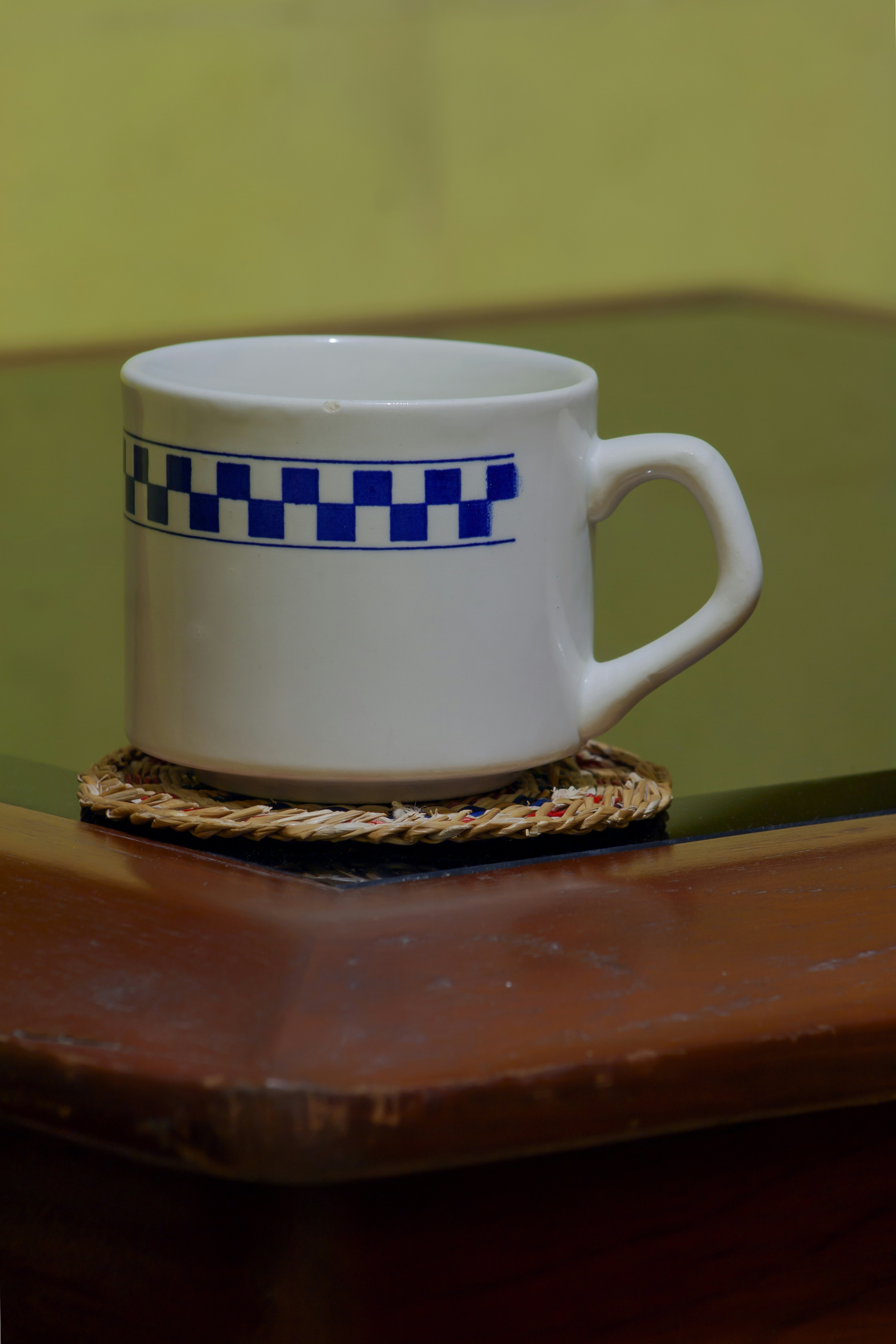 a white coffee cup on a coaster