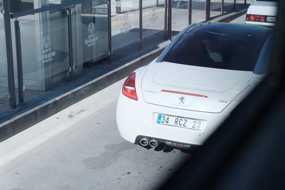 a white car parked on the side of a road