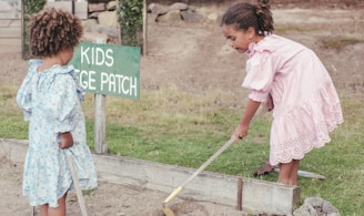 a couple of girls cleaning the ground