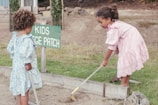 a couple of girls cleaning the ground
