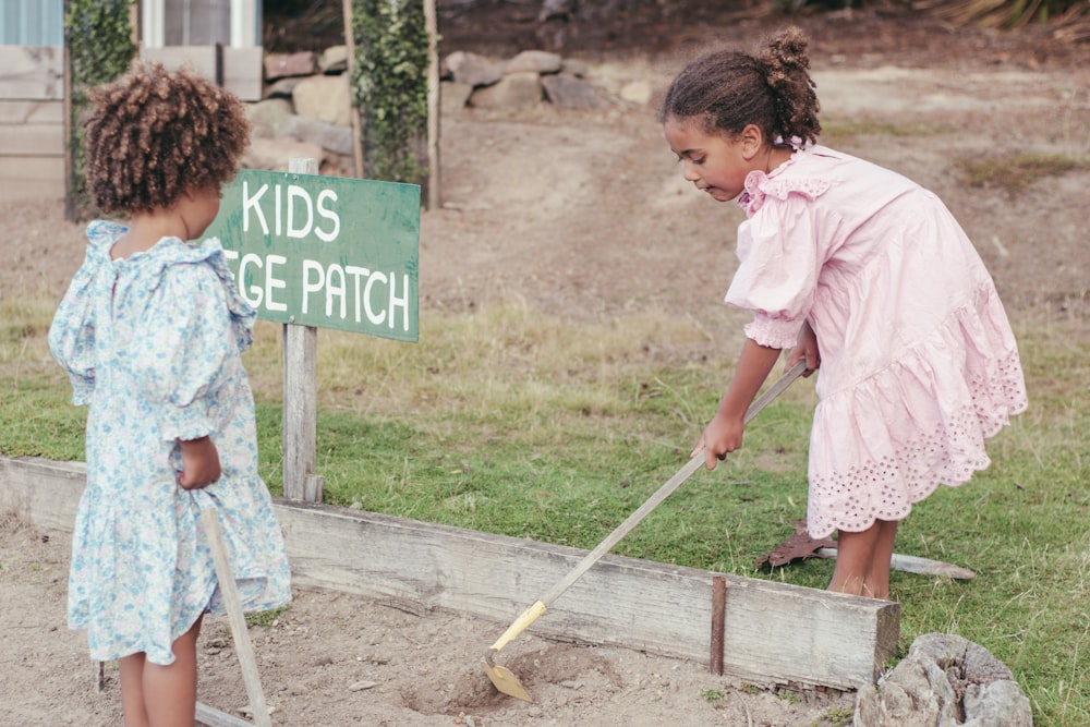 a couple of girls cleaning the ground