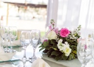 An elegant table setting adorned with a beautiful centerpiece of flowers.